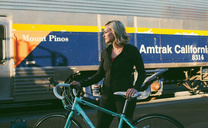 Woman with bike on train station platform